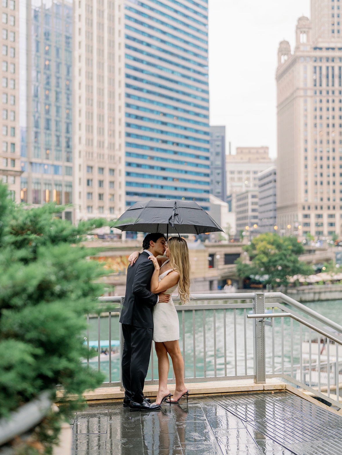 Kennedy and Corbin engagement photo, kissing under an umbrella